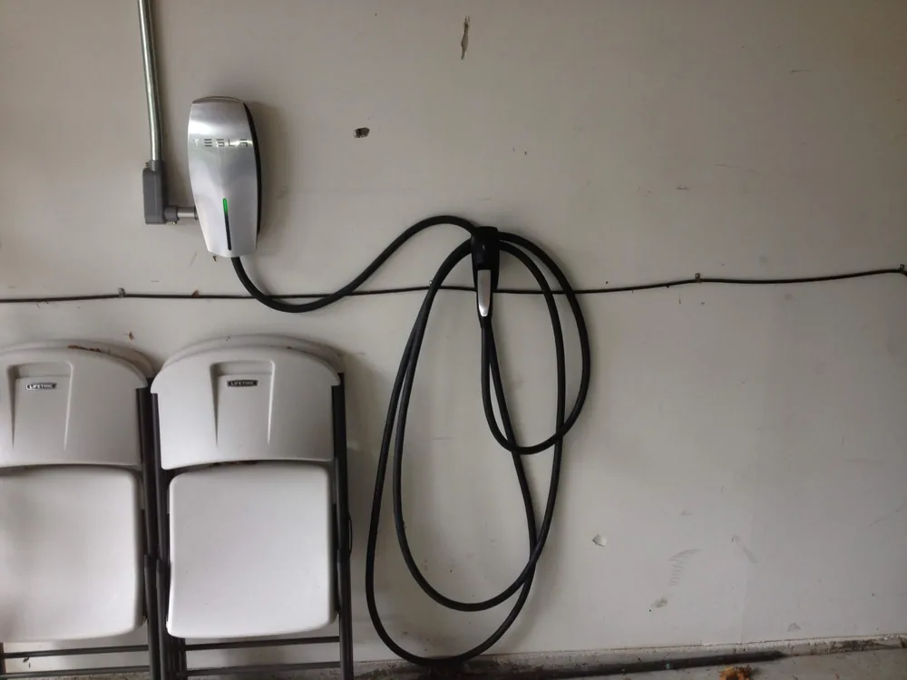 Tesla Wall Connector installed in a garage by Elite Electric